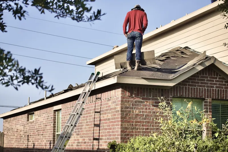 Professional roofer working on a residential roof in Deale